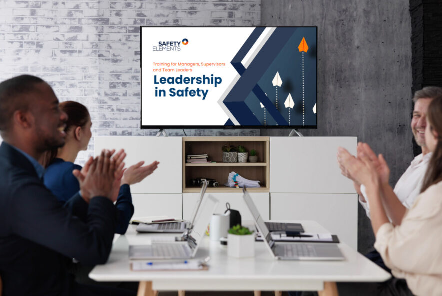 A team of managers participating in a "Leadership in Safety" training session, engaging in discussions on workplace safety, risk management, and fostering a strong safety culture.